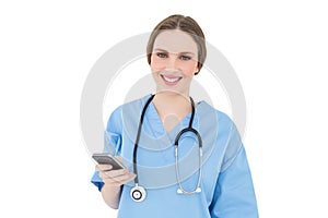 Young woman doctor holding her smartphone