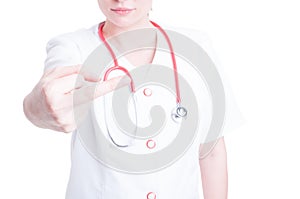 Young woman doctor making a rude gesture