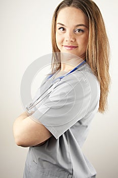 Young woman doctor or nurse wearing scrubs