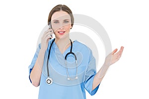 Young woman doctor phoning and making a gesture