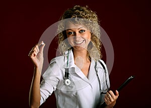 Young woman doctor with a pill