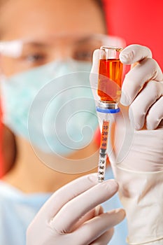 Young woman doctor preparing injection