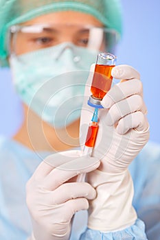 Young woman doctor preparing injection