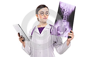 Young woman doctor with stethoscope looking at x-ray making diagnosis in white uniform on white background