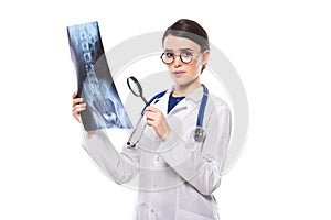 Young woman doctor with stethoscope looking at x-ray making diagnosis in white uniform on white background