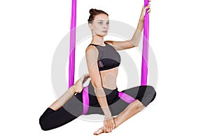 Young woman doing aerial yoga. Isolated on white.