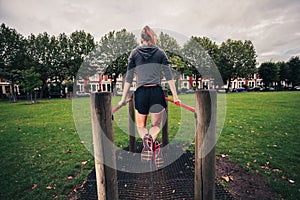 Young woman doing dips in the park
