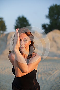 young woman doing eagle yoga pose