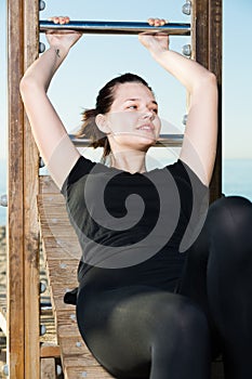 Young woman is doing exercise on abdominals