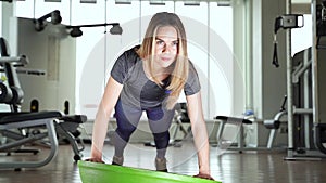 Young woman doing exercise on bosu ball.