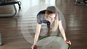 Young woman doing exercise on bosu ball. Top view