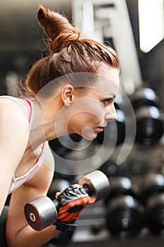 Young woman doing exercise in fitness center