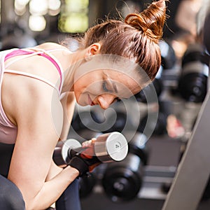 Young woman doing exercise in fitness center