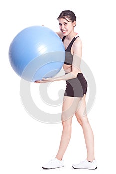 Young woman doing exercises with fitness ball