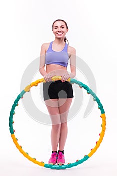 Young woman doing exercises with hoop