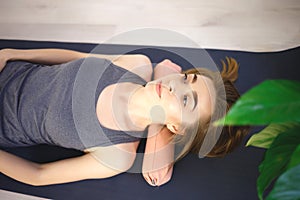 Young woman doing exercises on a massage roller