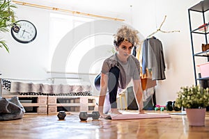 Young woman doing fitness exercise at home