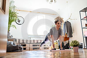 Young woman doing fitness exercise at home