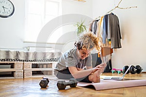 Young woman doing fitness exercise at home