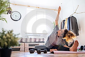 Young woman doing fitness exercise at home