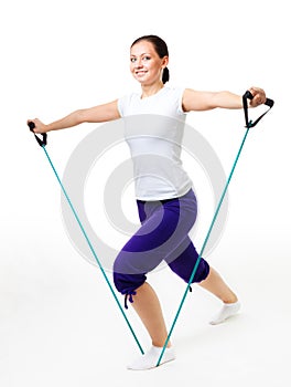 Young woman doing fitness with expander