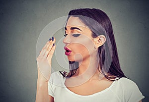Young woman doing a hand breath test