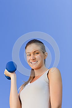 Young woman doing her exercises in the park
