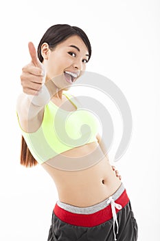 Young woman doing her workout with thumb up