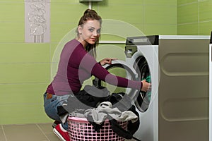 Young Woman Doing Housework Laundry