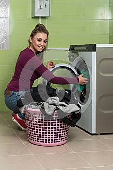 Young Woman Doing Housework Laundry