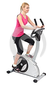 Young woman doing indoor biking exercise