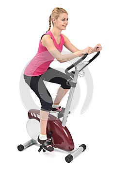 Young woman doing indoor biking exercise