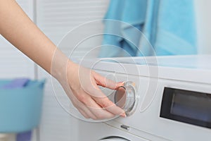 Young woman doing laundry at home,