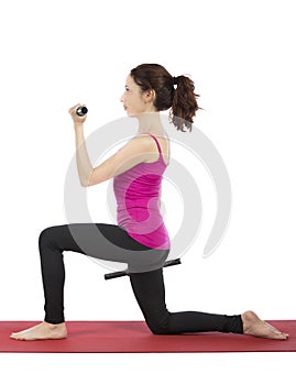 Young woman doing lunge with dumbbells