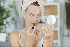 young woman doing make-up after shower