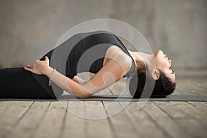 Young woman doing Matsyasana exercise, close up