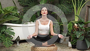 Young woman doing morning yoga and meditation in her bedroom. Blithe