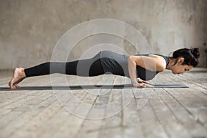 Young woman doing Push ups or press ups