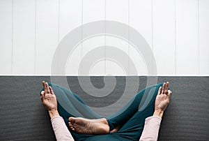Young woman doing relaxation exercise, practicing yoga, girl meditating at home.