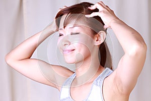 Young woman doing self head massage