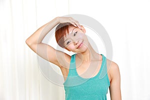 Young woman doing self neck stretch