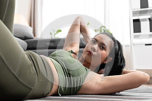 Young woman doing sit up exercise workout at home