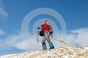 Young woman doing ski touring in winter mountains