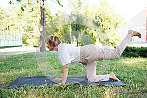 Young woman doing sports in a green park. A natural and impressive environment