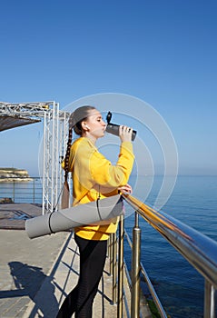 Young woman doing sports outdoors by the sea