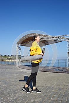 young woman doing sports outdoors by the sea