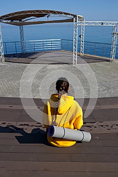 Young woman doing sports outdoors by the sea