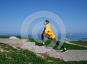 young woman doing sports outdoors by the sea