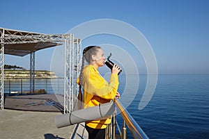 young woman doing sports outdoors by the sea