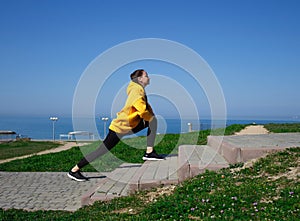 Young woman doing sports outdoors by the sea